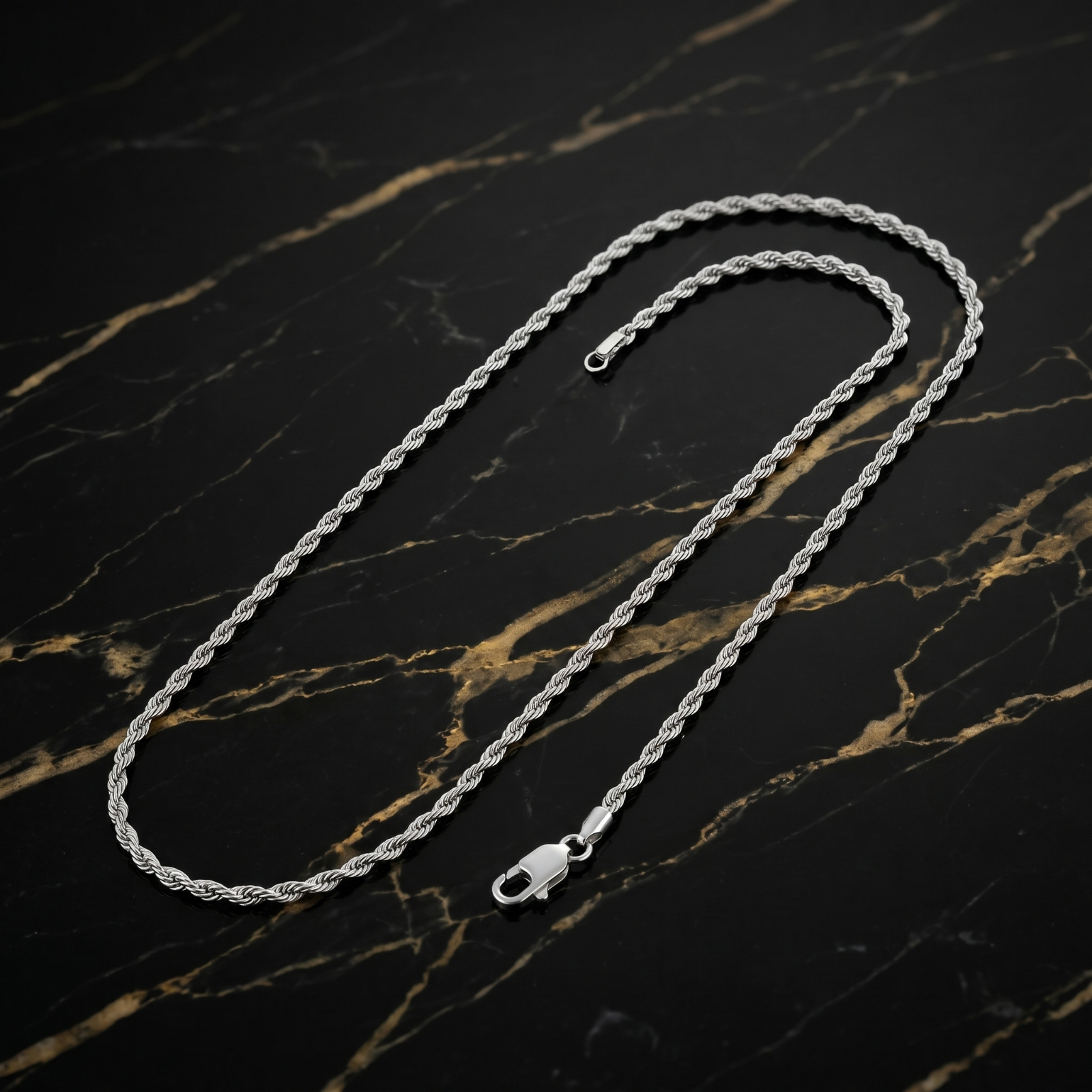 1MM Solid 925 Sterling Silver Italian Diamond Cut Rope Chain Necklace on a black marble surface