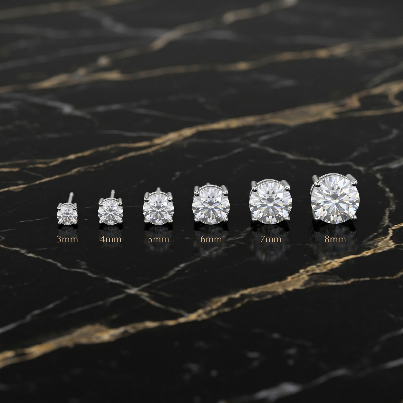 Moissanite Stud Earrings in 3mm, 4mm, 5mm, 6mm, 7mm, and 8mm sizes on a black marble surface