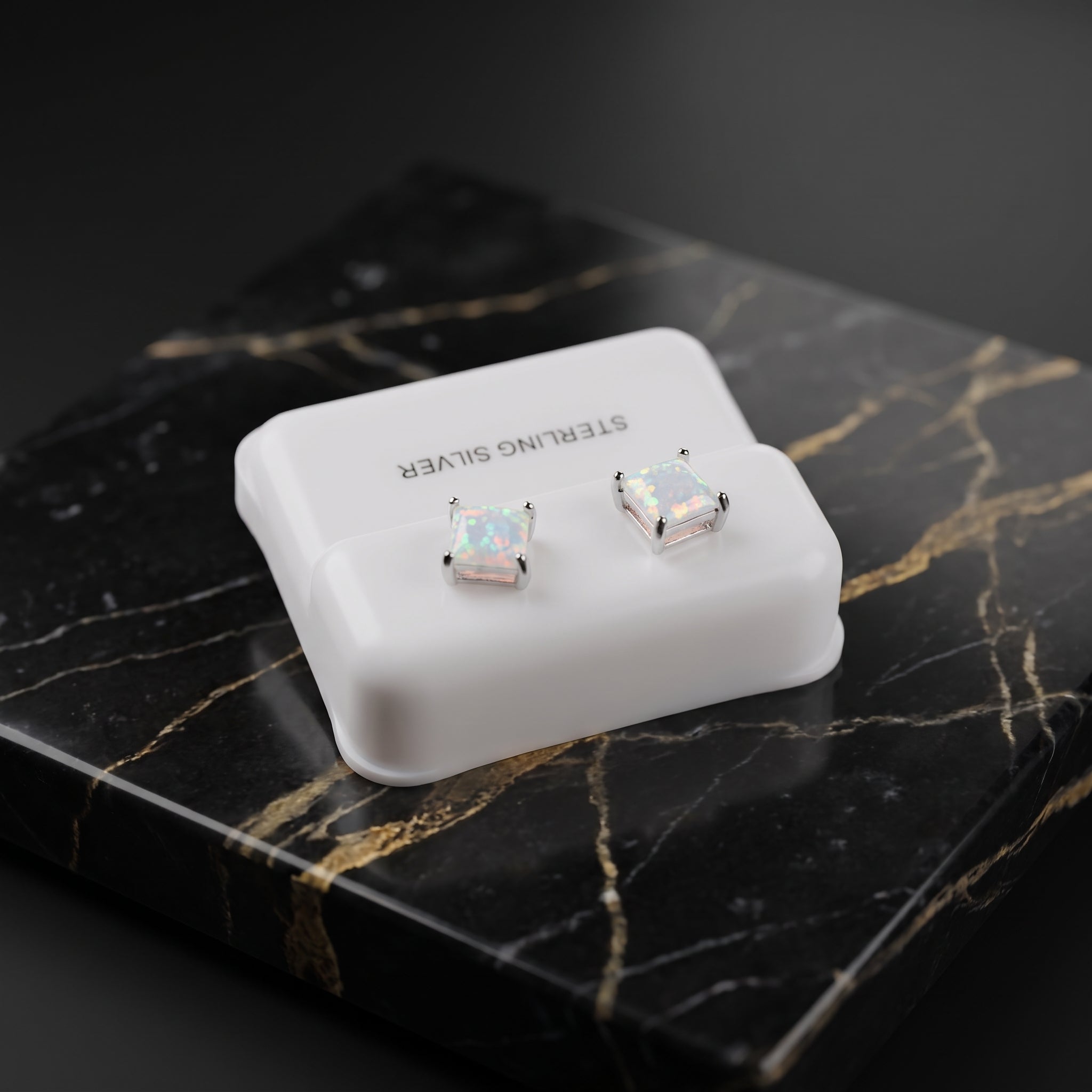 White opal square stud earrings in 925 sterling silver on a white display stand
