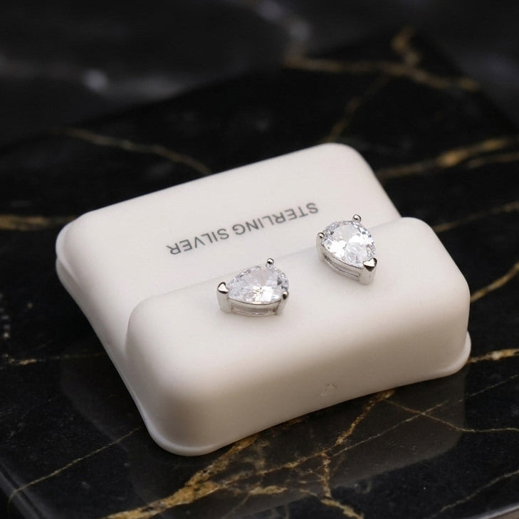 Pear CZ Earrings Clear 925 Sterling Silver 6x9mm Push Back on a white display stand