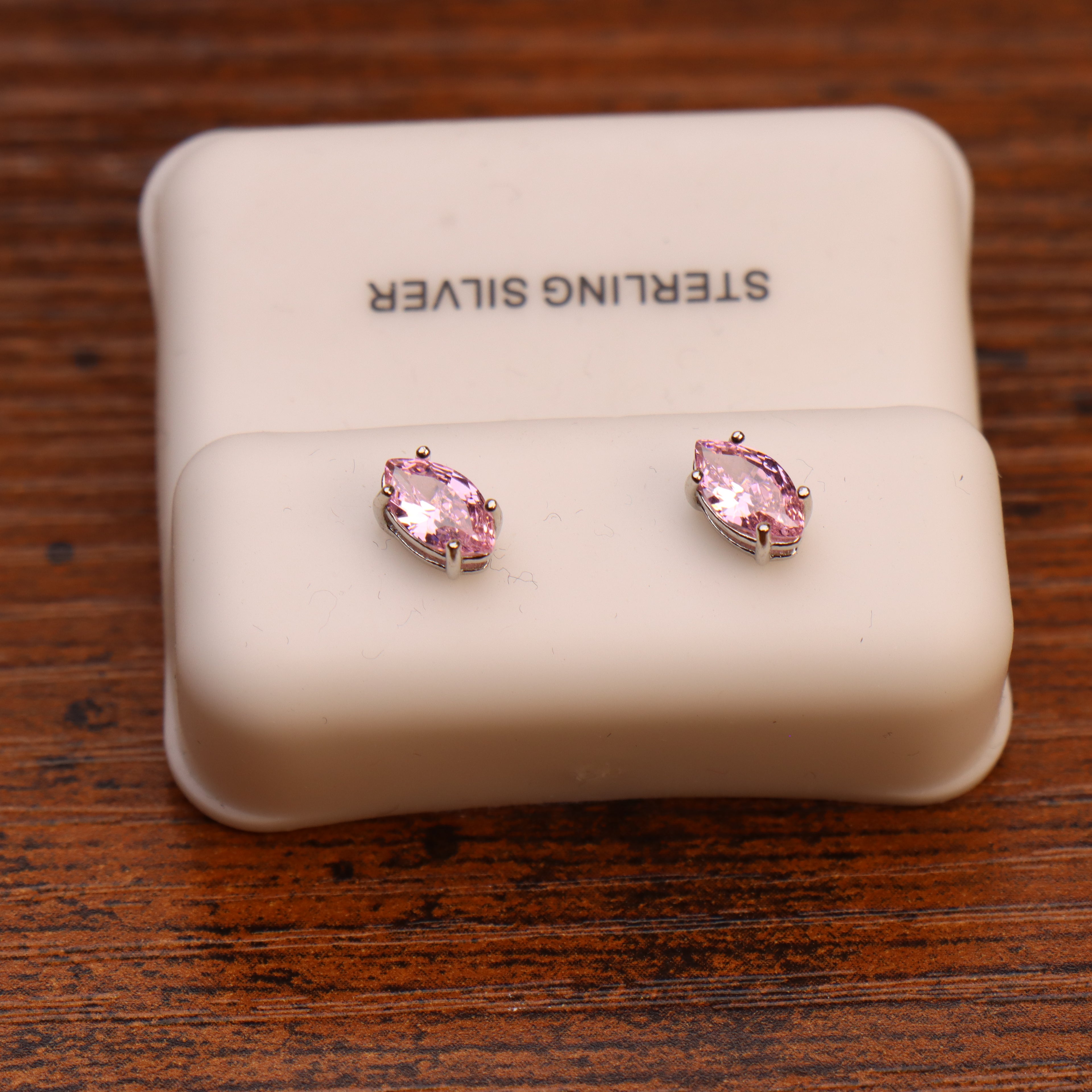 Marquise pink CZ stud earrings in 925 sterling silver on a display stand