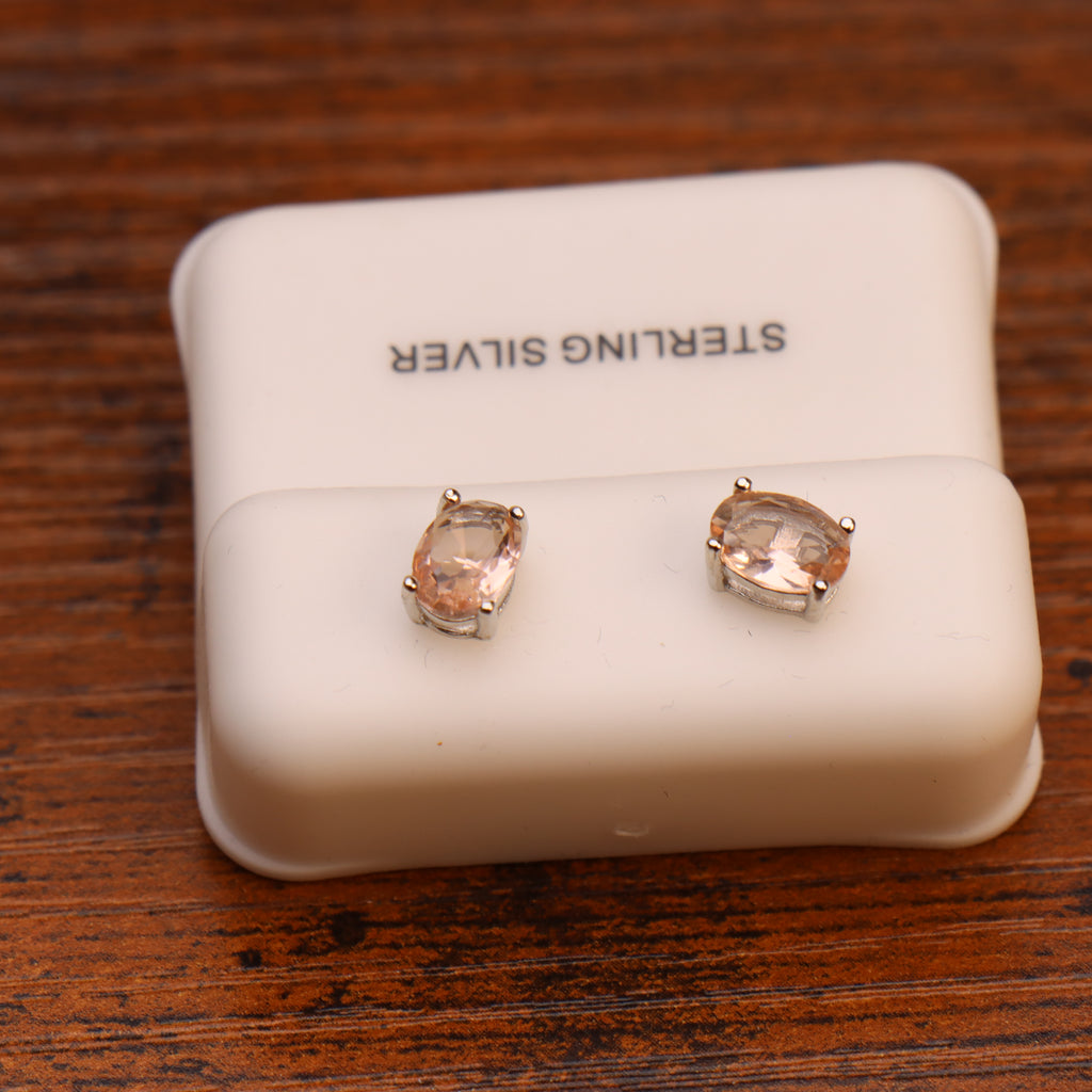 Morganite CZ oval stud earrings in 925 sterling silver on a white display stand