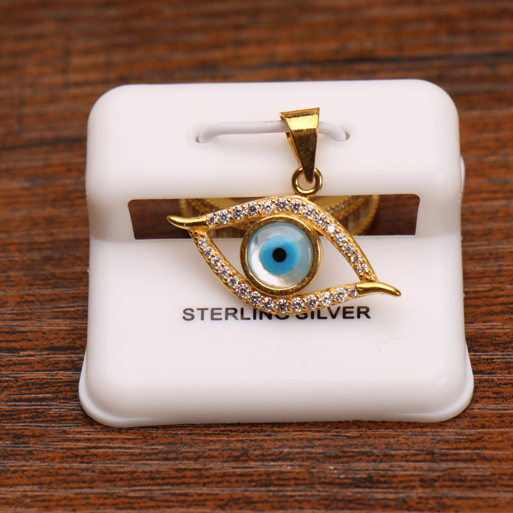 Evil eye pendant charm in 14k gold over sterling silver with clear stones on a white display stand