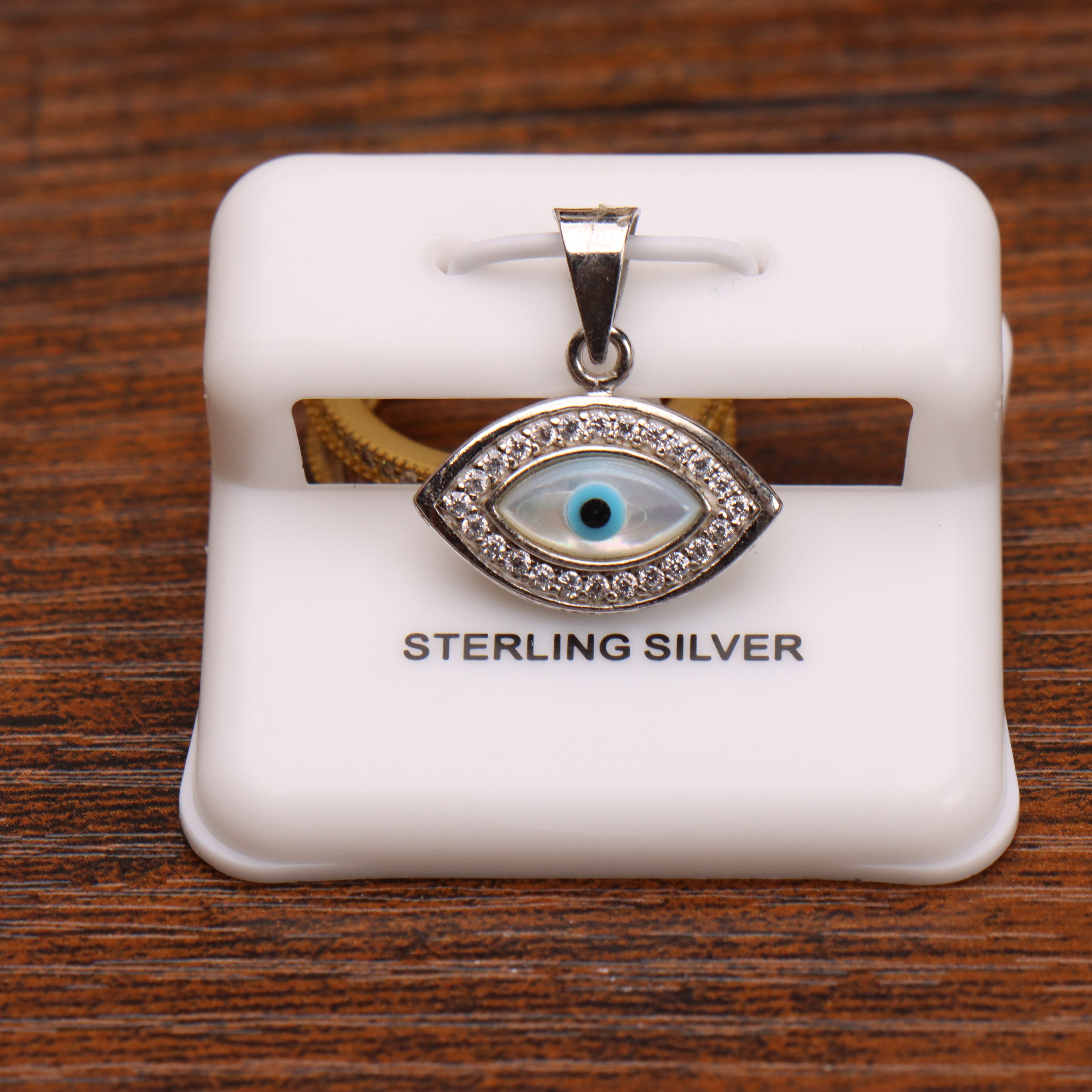 Evil eye CZ halo pendant in 925 sterling silver on a white display stand