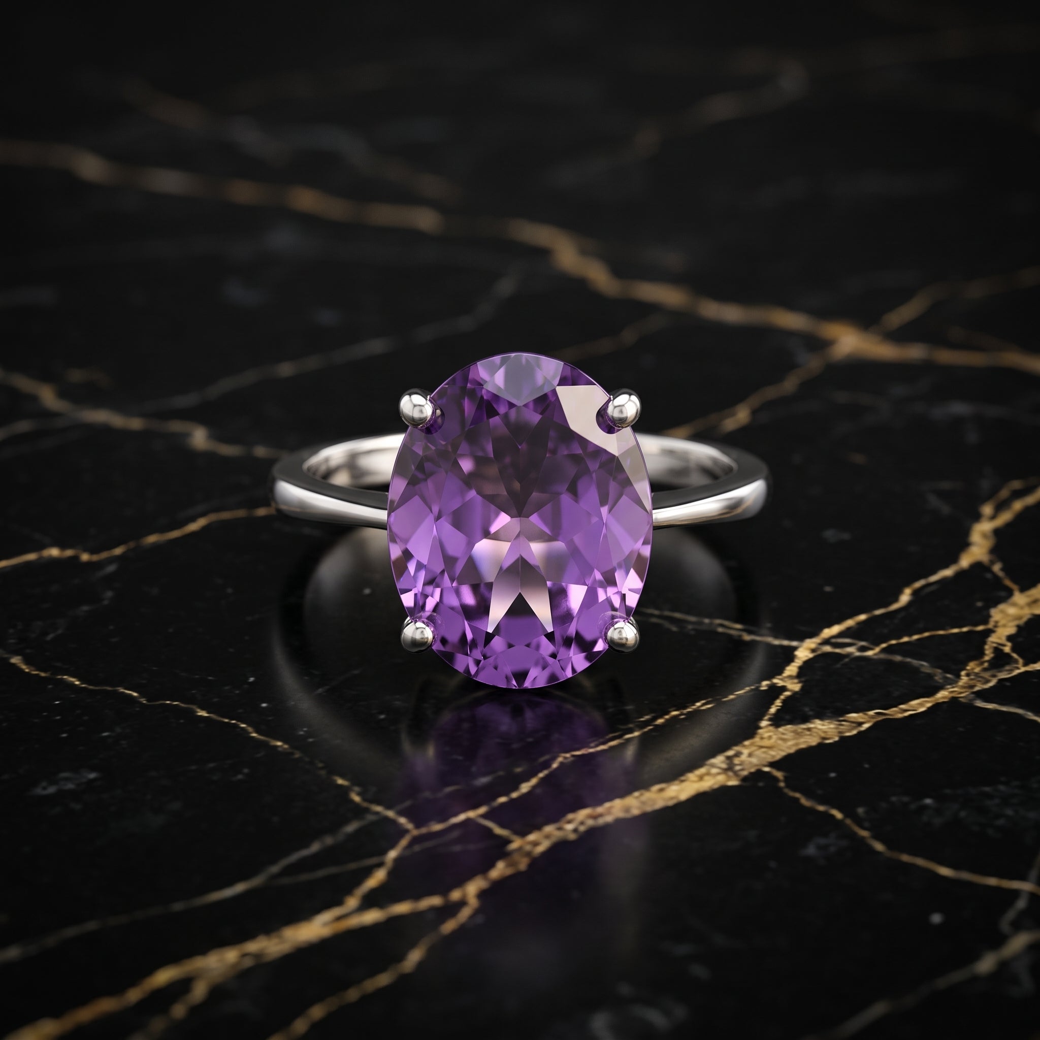 An oval-cut purple amethyst ring in a silver four-prong setting, displayed on a black marble surface with gold veining.