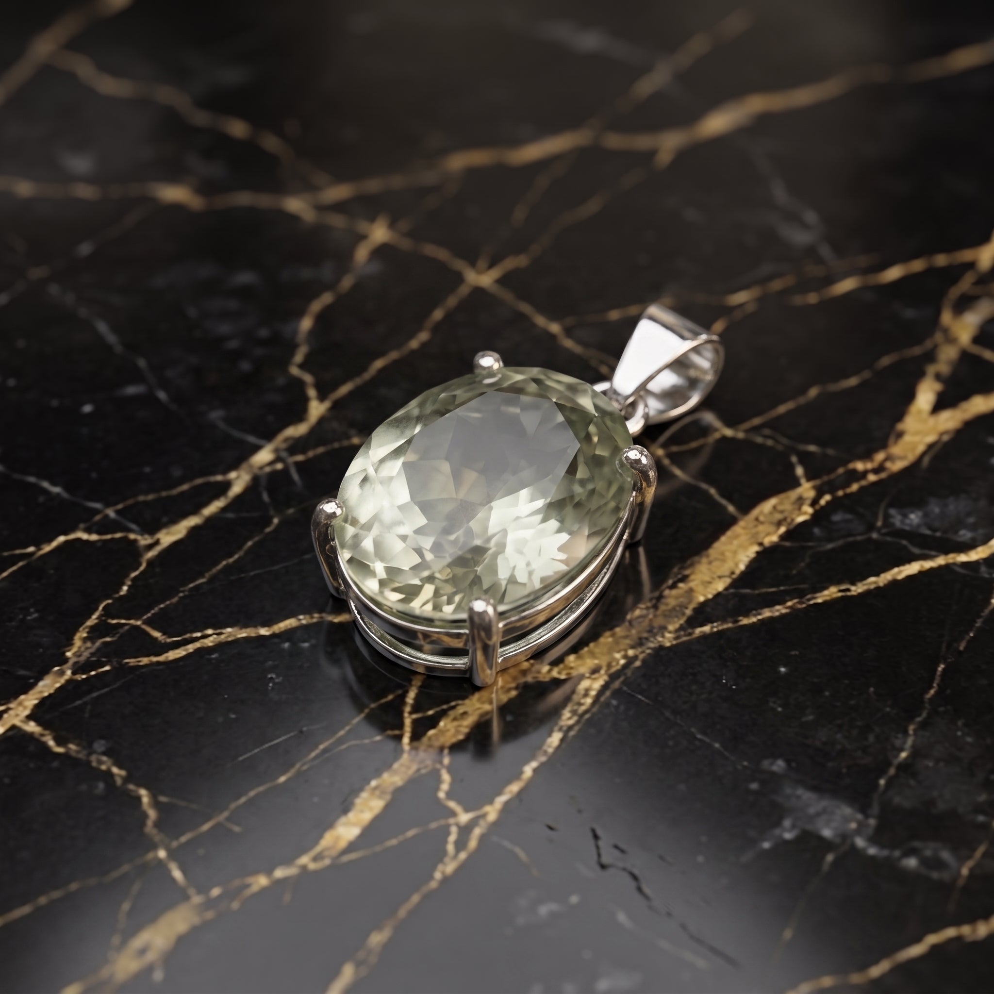 Green amethyst oval pendant in 925 sterling silver on a black marble surface