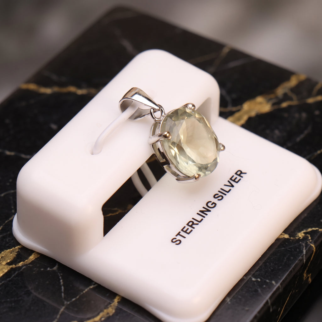 Green amethyst oval semi precious natural pendant in 925 sterling silver on a white display stand