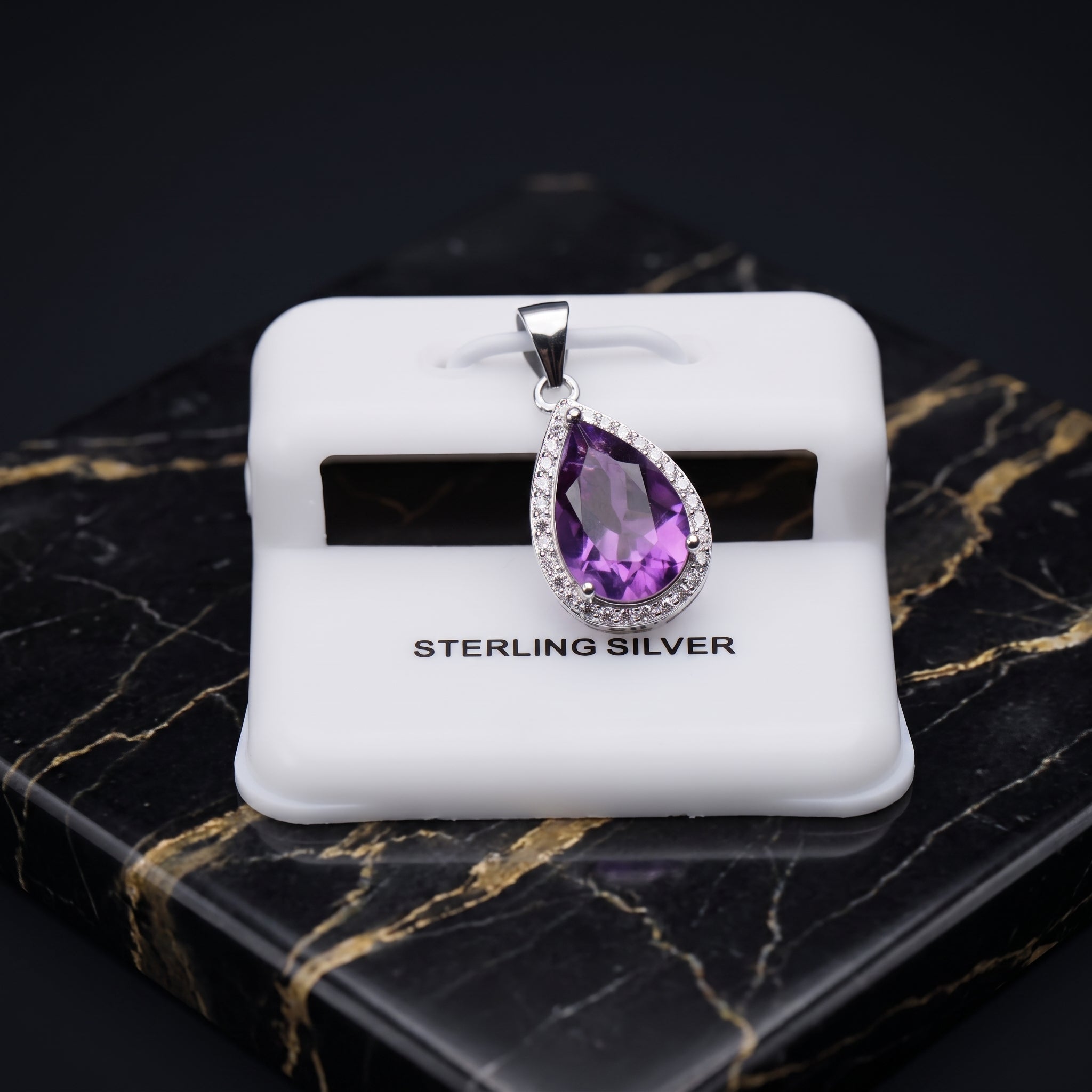 Amethyst pear shaped pendant with a cubic zirconia halo set in 925 sterling silver