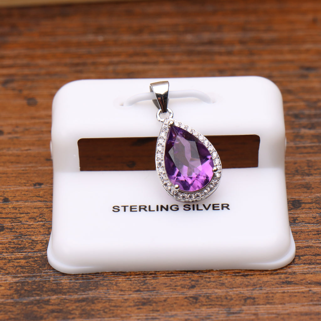 Amethyst pear shaped pendant with a cubic zirconia halo set in 925 sterling silver on a white display stand