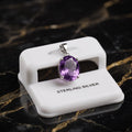 Amethyst oval semi precious natural pendant in 925 sterling silver on a white display stand