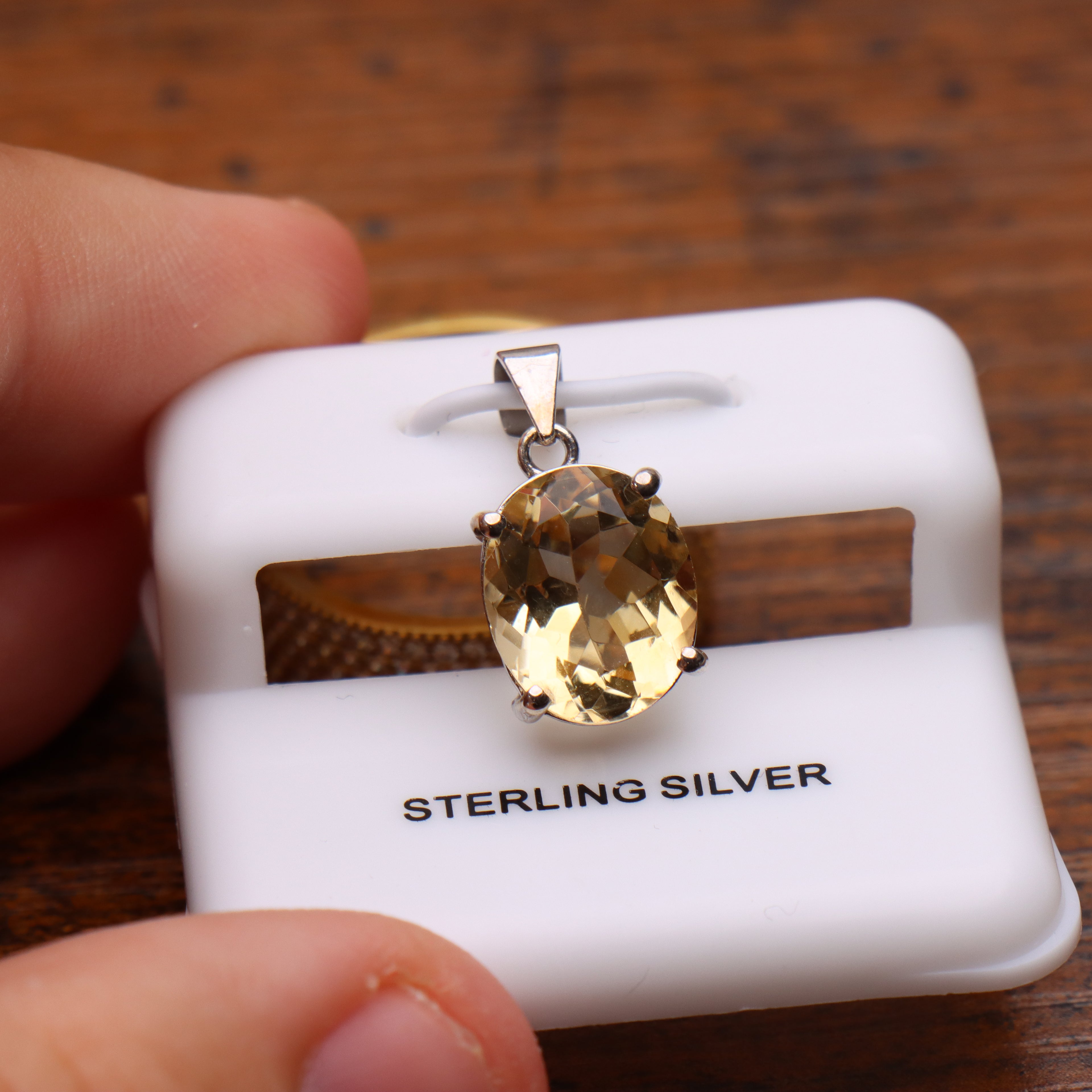 Citrine oval semi precious natural pendant in 925 sterling silver on a white display card