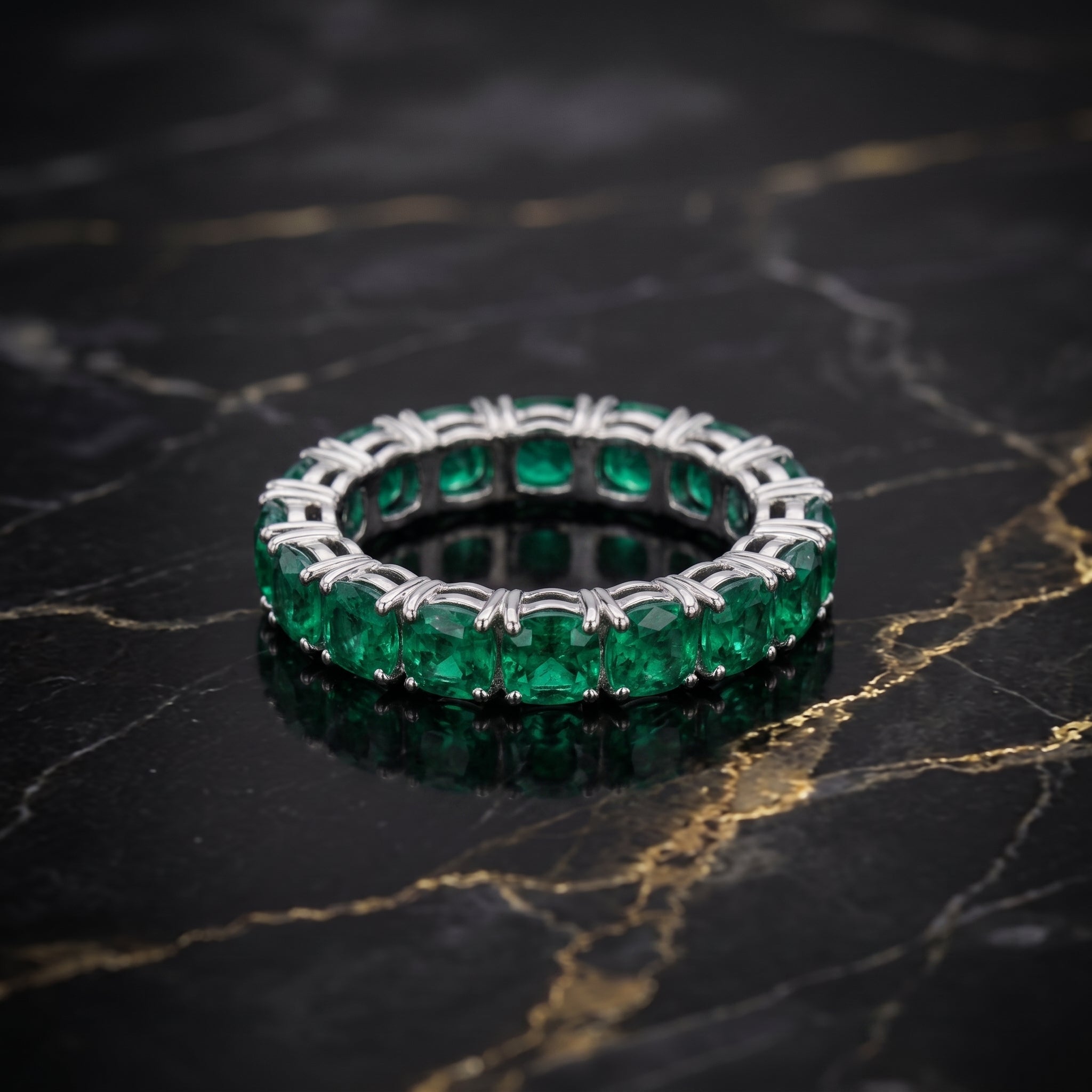 Green CZ eternity band ring in 925 sterling silver with round cut stones on black marble surface