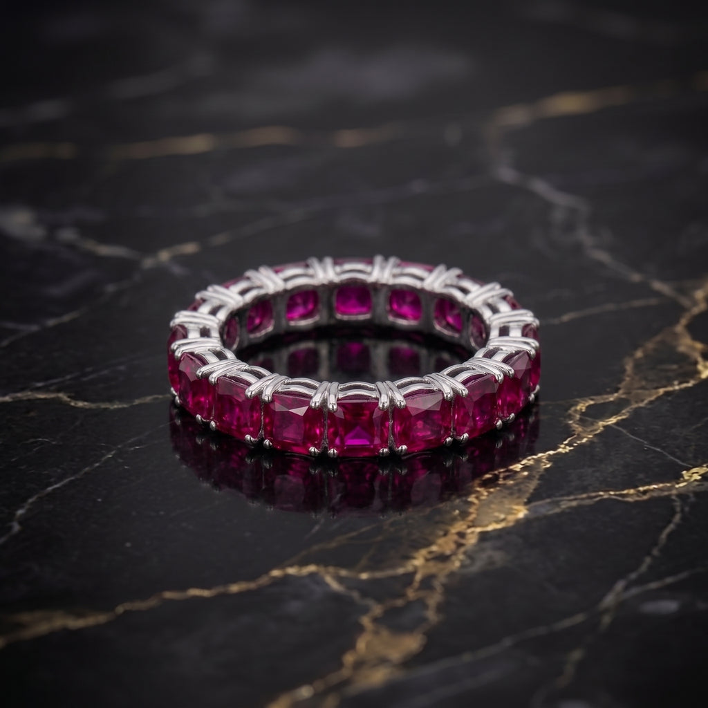 Magenta ruby CZ eternity band ring in 925 sterling silver on a black marble surface